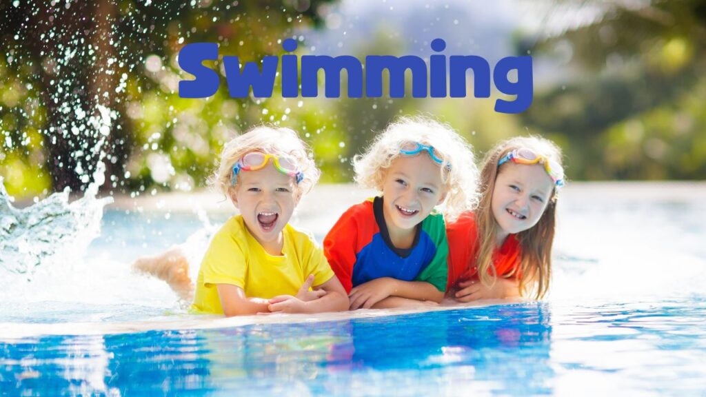 Three children in the water with a word swimming above them.